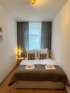 a bedroom with a large bed with two plates on it at Arminos Apartment Li in Chemnitz