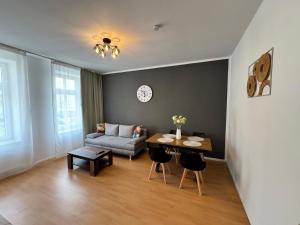 a living room with a couch and a table at Arminos Apartment Li in Chemnitz