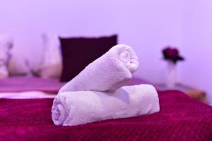 a towel animal is sitting on a bed at Luci's House B in São Jorge