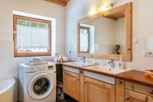 a bathroom with a washing machine and a sink at Ferienwohnung Toni II in Siusi