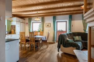 a kitchen and dining room with a table and chairs at Ferienwohnung Toni II in Siusi +20 photos