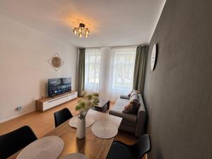 a living room with a table and a couch at Arminos Apartment Li in Chemnitz