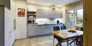 a kitchen with a table and a dining room at Wiesenblick in Brilon