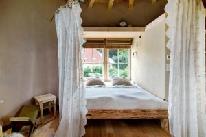 a bedroom with a bed and a window at Uptrulli-Minihaus in Vogt