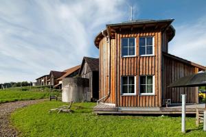 a wooden house with a large window on top of it at Uptrulli-Minihaus in Vogt