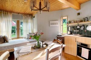a kitchen with a table and a dining room at Uptrulli-Minihaus in Vogt +27 photos