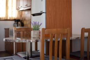a kitchen with a table and two chairs and a table at Virginia’s house in Andros +10 photos