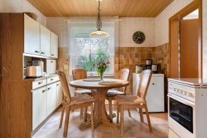 a kitchen with a table and chairs in a kitchen at Ferienwohnung Alberto in Drelsdorf +16 photos