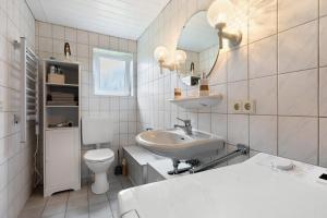 a white bathroom with a sink and a toilet at Ferienwohnung Alberto in Drelsdorf