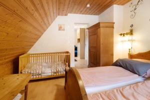 a bedroom with two beds and a crib at Buchhaus Vier - Dachgeschoss in Kirchenlamitz