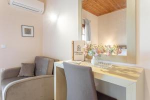 a dining room with a table and two chairs at Dimaras Apartments Zakynthos in Vasilikos +168 photos