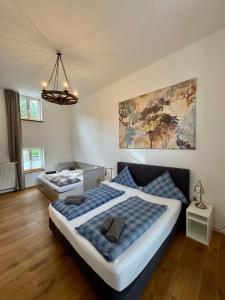 a bedroom with two beds and a painting on the wall at Gut Wenne in Eslohe