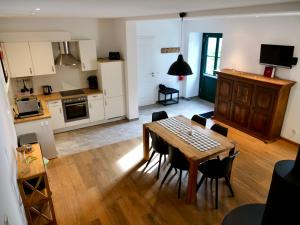 a kitchen and dining room with a table and chairs at Gut Wenne in Eslohe