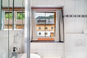 a bathroom with a window with a view of a building at Gasthaus Mamoosen in Penning