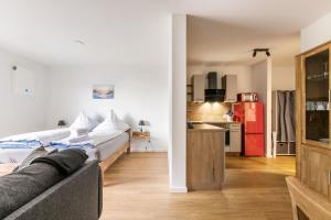 a living room with a couch and a kitchen at Hodderup Wohnung 10 in Husby