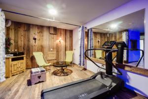 a gym with a treadmill and a table and chairs at Anémone in Valloire