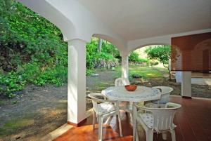 a patio with a table and chairs on a porch at Can Botana 3 in Cala de Sant Vicenc