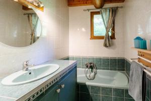 a bathroom with a sink and a tub at Anémone in Valloire +17 photos