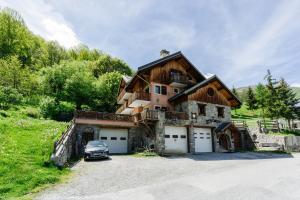 a large house with a car parked in front of it at Anémone in Valloire