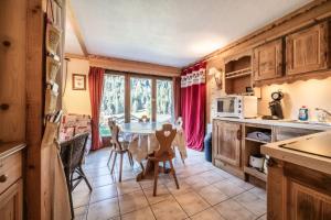 a kitchen and dining room with a table and chairs at Duo d'appartements - Chatel in Châtel