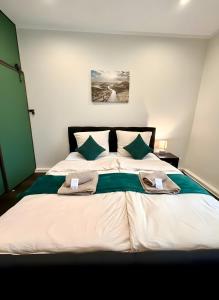 a bedroom with a large bed with towels on it at Altstadt-Oase 2 in Cottbus