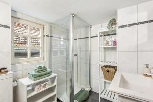 a bathroom with a shower and a sink at Das Häuschen 1650 in Alsfeld +16 photos