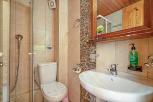 a bathroom with a toilet and a sink and a shower at Nontas Home 21 in Kalamitsi +23 photos