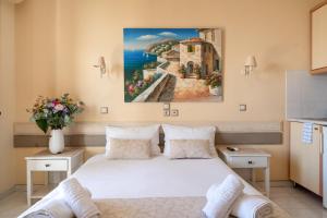 a bedroom with a bed with a painting on the wall at Nontas Home 21 in Kalamitsi