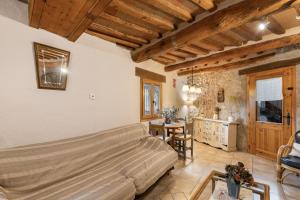 a living room with a couch and a table at Cal Torrentí in Caserras