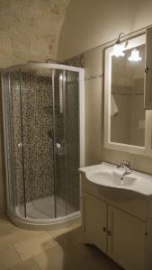 a bathroom with a shower and a sink at Trullo Pesco in Martina Franca +7 photos