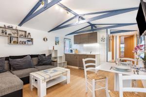 a living room with a couch and a table at Bungalow Uschi - Bgl 29 in Dranske