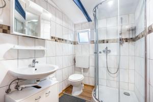 a bathroom with a toilet sink and a shower at Bungalow Uschi - Bgl 29 in Dranske +17 photos