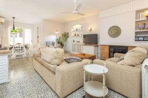 a living room with two couches and a fireplace at Ca L' Anton in Palafrugell