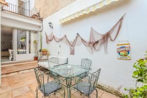 a patio with a glass table and chairs at Ca L' Anton in Palafrugell