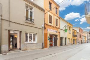 an empty street in a town with buildings at Ca L' Anton in Palafrugell