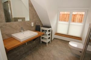 a bathroom with a sink and a toilet at Gut Wenne in Eslohe +37 photos