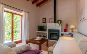 a living room with a couch and a fireplace at Es Romagueral in Artá