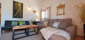 a living room with a couch and a table at Casa s’Hort - Can Rita in Llombarts +33 photos