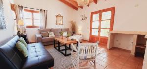 a living room with a couch and a table at Casa s’Hort - Can Rita in Llombarts