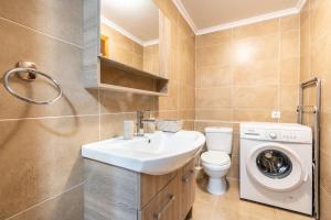 a bathroom with a sink and a washing machine at Absinthia Fanes in Rhodes Town +65 photos