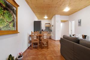 a living room with a couch and a table and chairs at Casa Verol B in Moya