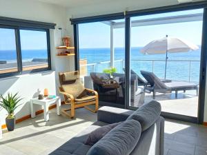 a living room with a view of the ocean at The Wave House - Two Bedroom Flat in Jardim do Mar