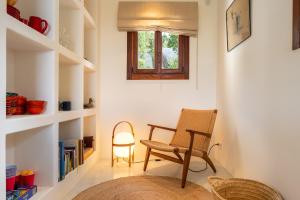 a room with a chair and a table and a window at Casa Juliarina in Sant Josep de sa Talaia