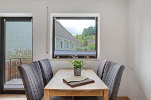 a dining room table with chairs and a window at Gästehaus Schwörer in Lenzkirch