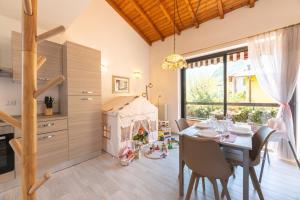 a kitchen and dining room with a table and chairs at Begna Kiddie Paradise Poolside Retreat in Porlezza