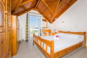 a bedroom with a large bed with a wooden ceiling at Tamar Apartments, Laganas in Laganas