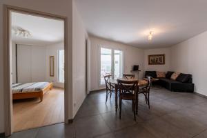 a living room with a table and a couch at La Providence in Annecy