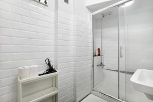 a white bathroom with a shower and a sink at Las Teresitas Beach Apartment in San Andrés +19 photos