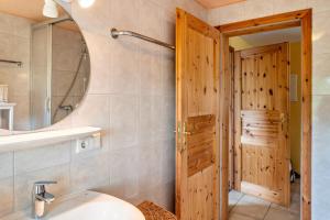 a bathroom with a toilet and a sink and a mirror at Dachstudio Seeblick in Krüselin +36 photos