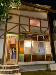 a house with a large window and a door at casa glamping in Lunahuaná
